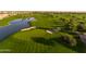 Aerial view of a lush golf course with a lake at 856 E Harmony Way, San Tan Valley, AZ 85140