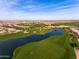 Aerial view of a golf course and lakefront property at 856 E Harmony Way, San Tan Valley, AZ 85140