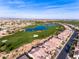 Aerial view of a community near a golf course and lake at 856 E Harmony Way, San Tan Valley, AZ 85140