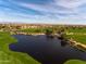Aerial view of a community with a golf course and lake at 856 E Harmony Way, San Tan Valley, AZ 85140