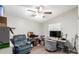 Home office featuring a desk, comfortable armchair, and large TV at 9431 E Coralbell Ave # 53, Mesa, AZ 85208