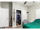 Bedroom with a closet, a bed with green bedding and a chair at 9431 E Coralbell Ave # 53, Mesa, AZ 85208
