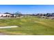 Green grassy area with a walking path and a playground in a community park at 4330 W Josephine St, San Tan Valley, AZ 85144