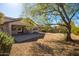 Spacious backyard with gravel and a large tree at 1724 W Hemingway Ln, Anthem, AZ 85086