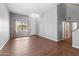 Living room with a neutral color scheme, wood-look floors, and access to other rooms at 1724 W Hemingway Ln, Anthem, AZ 85086