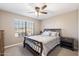 Well-lit bedroom with a queen-size bed and golf course view at 2110 Leisure World --, Mesa, AZ 85206