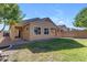 Tan house with a covered patio and grassy yard at 736 E Gold Dust Way, San Tan Valley, AZ 85143