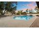 Backyard oasis featuring a sparkling pool and a cozy fire pit at 16002 N 44Th St, Phoenix, AZ 85032