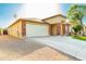 Exterior view of a single-story home with a two-car garage and a brick and stucco facade at 2741 W Pecan Rd, Phoenix, AZ 85041