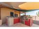 Outdoor kitchen with built-in grill and ample counter space at 3611 N 197Th Ct, Buckeye, AZ 85396