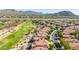 Aerial view of homes near a golf course and mountains at 6646 E Sugarloaf St, Mesa, AZ 85215