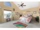 Relaxing main bedroom with high ceilings, a ceiling fan, and a large window offering scenic views at 6646 E Sugarloaf St, Mesa, AZ 85215