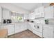 White kitchen with stainless steel appliances and a view into the dining area at 13051 N 75Th Dr, Peoria, AZ 85381