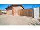 Attached garage with a wooden gate leading to the backyard at 13051 N 75Th Dr, Peoria, AZ 85381