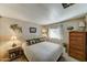 Comfortable bedroom with a wooden dresser and a cozy bed at 9333 E University Dr # 177, Mesa, AZ 85207