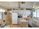 Well-equipped kitchen featuring white cabinets and a kitchen island at 9333 E University Dr # 177, Mesa, AZ 85207