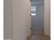 Clean hallway with wood-look tile floors leading to a bedroom at 24078 W Pecan Rd, Buckeye, AZ 85326