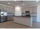 Modern kitchen with gray cabinets and an island at 24078 W Pecan Rd, Buckeye, AZ 85326