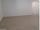 Spacious living room featuring light walls and wood-look tile floors at 24078 W Pecan Rd, Buckeye, AZ 85326