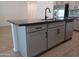 Kitchen island with dark countertop and gray cabinetry at 24078 W Pecan Rd, Buckeye, AZ 85326
