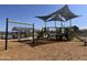 Community playground with shaded play structure at 24078 W Pecan Rd, Buckeye, AZ 85326