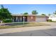 Single-story home with a covered patio and a lush front yard at 10861 W Venturi Dr, Sun City, AZ 85351