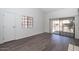 Living room with wood-look floors, sliding glass door to balcony at 6550 N 47Th Ave # 235, Glendale, AZ 85301