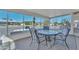 Relaxing screened porch with table and chairs at 13018 W Limewood Dr, Sun City West, AZ 85375