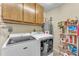 Laundry room with washer, dryer, and storage shelves at 13018 W Limewood Dr, Sun City West, AZ 85375