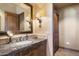 Vanity with granite countertop, large mirror and ample storage at 9743 E Madera Dr, Scottsdale, AZ 85262