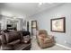 Relaxing bedroom with leather seating and large mirror at 18545 N Wilson St, Maricopa, AZ 85138