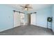 Light blue bedroom with tile floors, ceiling fan, and barn door at 28480 N Bryce Trl, San Tan Valley, AZ 85144