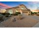 Two-story home with attractive landscaping and desert-inspired design at 7360 E Rustling Pass, Scottsdale, AZ 85255