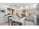 Modern kitchen with white cabinets, stainless steel appliances, and a large island at 7360 E Rustling Pass, Scottsdale, AZ 85255