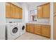 Laundry room with washer, dryer, and plenty of cabinets at 23461 N 80Th Way, Scottsdale, AZ 85255