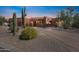 Beautiful desert landscape with a stucco home and brick driveway at 23461 N 80Th Way, Scottsdale, AZ 85255