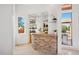 Wet bar with stone countertop and mirrored backsplash at 23461 N 80Th Way, Scottsdale, AZ 85255
