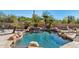 Inviting pool and spa with a waterfall feature, desert landscaping, and patio furniture at 23461 N 80Th Way, Scottsdale, AZ 85255