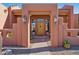 Elegant entryway with a wooden door and brick accents at 23461 N 80Th Way, Scottsdale, AZ 85255