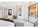 Spacious bedroom with fireplace, access to patio, and built-in shelving at 23461 N 80Th Way, Scottsdale, AZ 85255