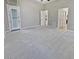 Spacious main bedroom with plush carpeting and access to other rooms at 12446 W Bajada Rd, Peoria, AZ 85383
