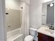 Bathroom with tub, toilet, and vanity with dark wood cabinets at 12446 W Bajada Rd, Peoria, AZ 85383