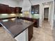 Island kitchen with dark wood cabinets and granite countertops at 12446 W Bajada Rd, Peoria, AZ 85383