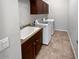 Laundry room with washer, dryer, sink, and built-in cabinets at 12446 W Bajada Rd, Peoria, AZ 85383