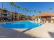 Community pool with lounge chairs and grilling station at 14950 W Mountain View Blvd # 4205, Surprise, AZ 85374