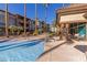 Community pool with spa and surrounding patio area at 14950 W Mountain View Blvd # 4205, Surprise, AZ 85374