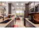 Modern kitchen with dark cabinetry, granite countertops, and stainless steel appliances at 14950 W Mountain View Blvd # 4205, Surprise, AZ 85374