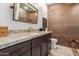 Modern bathroom with granite countertop and copper-tiled shower at 14950 W Mountain View Blvd # 4205, Surprise, AZ 85374