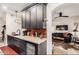 Kitchen with granite countertops, wine fridge, and view into the living room at 14950 W Mountain View Blvd # 4205, Surprise, AZ 85374