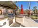 Outdoor grilling station with multiple grills and seating area at 14950 W Mountain View Blvd # 4205, Surprise, AZ 85374